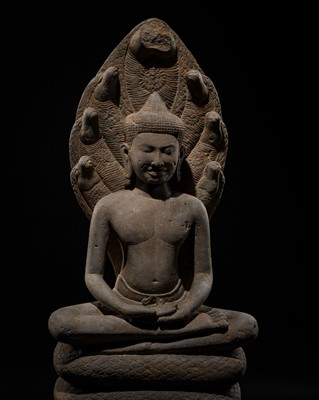 Lot 51 - AN EXCEPTIONALLY WELL-PRESERVED SANDSTONE FIGURE OF BUDDHA MUCHALINDA, BAYON STYLE, LATE 12TH-EARLY 13TH CENTURY