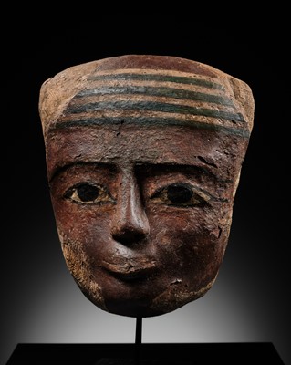 Lot 60 - A PAINTED CARTONNAGE MUMMY MASK, THIRD INTERMEDIATE PERIOD