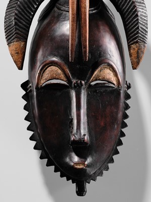 Lot 95 - A CARVED WOOD MASK, GYÈ, YAURE CULTURE, CÔTE D'IVOIRE, LATE 19TH TO EARLY 20TH CENTURY