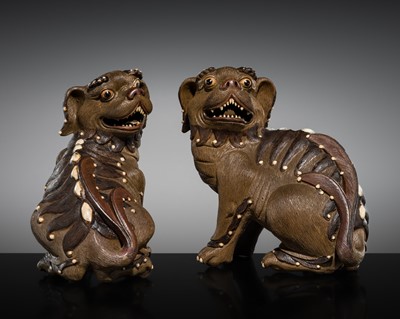 Lot 256 - AN UNUSUAL PAIR OF SHIWAN STONEWARE BUDDHIST LIONS, 19TH CENTURY