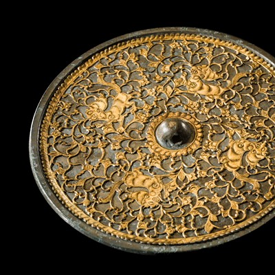 Lot 94 - AN UNUSUAL GILT-COPPER OVERLAY BRONZE MIRROR, TANG DYNASTY