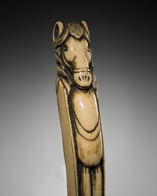 AN ANTLER ‘BLADE SHEATHE’ NETSUKE OF A HORSE