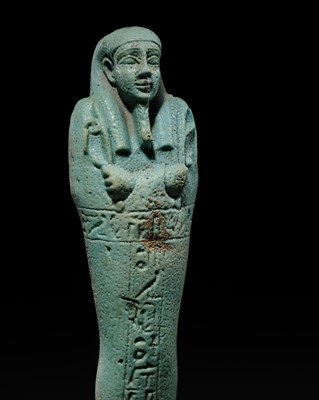 Lot 56 - A SUPERB PALE BLUE FAIENCE SHABTI OF NESBANEBDJED, DYNASTY XXX