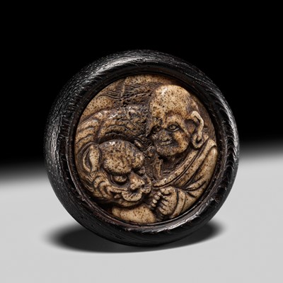 Lot 344 - HOSAI: A FINE ANTLER AND WOOD KAGAMIBUTA NETSUKE OF RAKAN HATTARA SONJA AND HIS TIGER