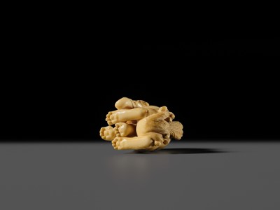 Lot 101 - A FINE IVORY NETSUKE OF A SEATED BAKU