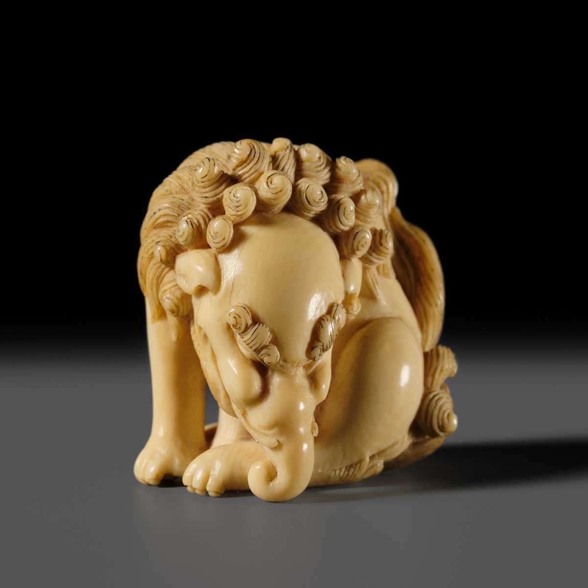 Lot 101 - A FINE IVORY NETSUKE OF A SEATED BAKU