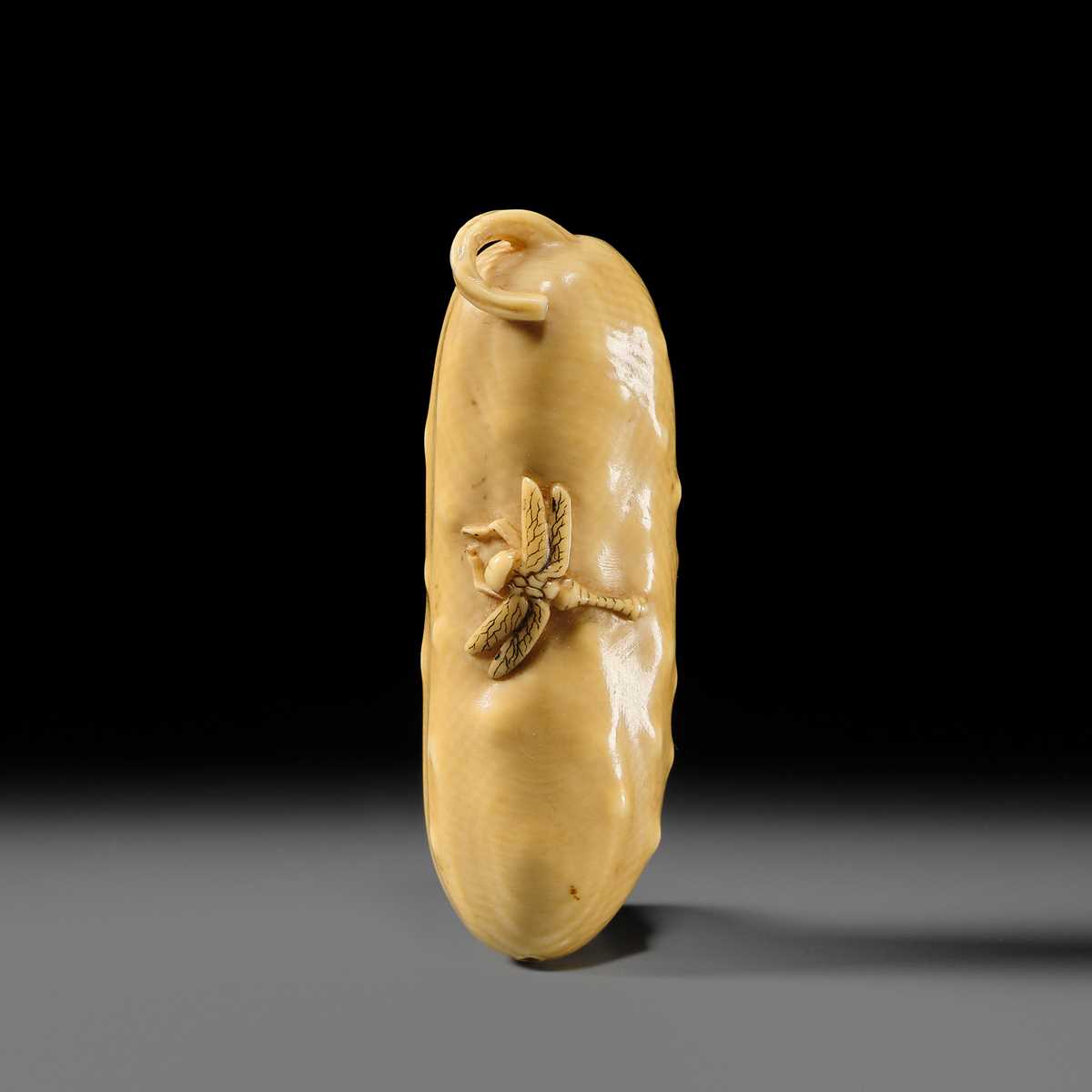 Lot 146 - MASAYOSHI: A FINE OSAKA SCHOOL IVORY NETSUKE OF A CUCUMBER AND DRAGONFLY