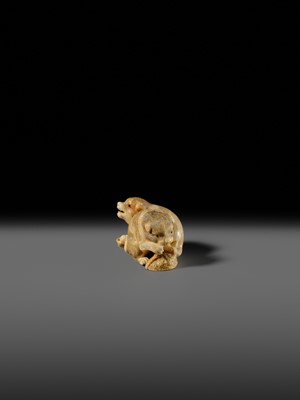 Lot 121 - OKATOMO: A CHARMING IVORY NETSUKE OF TWO PUPPIES WITH AWABI