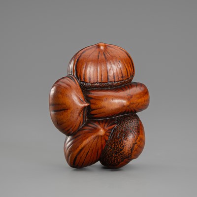 Lot 650 - A WOOD NETSUKE DEPICTING SIX CHESTNUTS