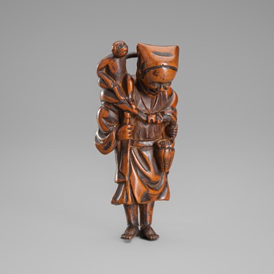 A FINE WOOD NETSUKE DEPICTING A SARUMAWASHI