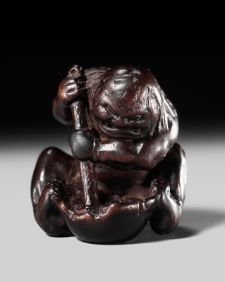 Lot 250 - A RARE WOOD NETSUKE OF AN ONI GRINDING BODY PARTS