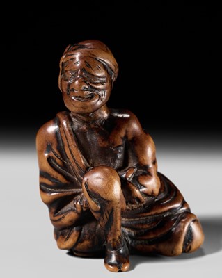 Lot 243 - AN EARLY EDO SCHOOL WOOD NETSUKE OF A MAN APPLYING MOXA