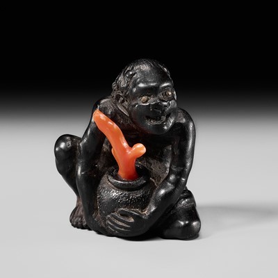 Lot 276 - AN EBONY WOOD AND CORAL NETSUKE OF A SOUTH SEA ISLANDER