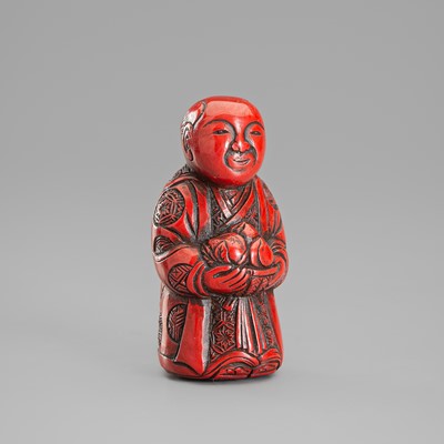 A TSUISHU LACQUER NETSUKE OF A CHINESE BOY