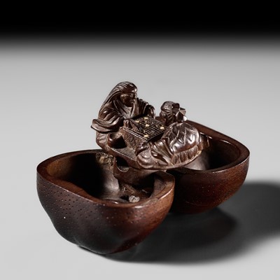 Lot 253 - A FINE WOOD KARAKURI (TRICK) NETSUKE OF TWO CHINESE SAGES PLAYING GO INSIDE A MIKAN