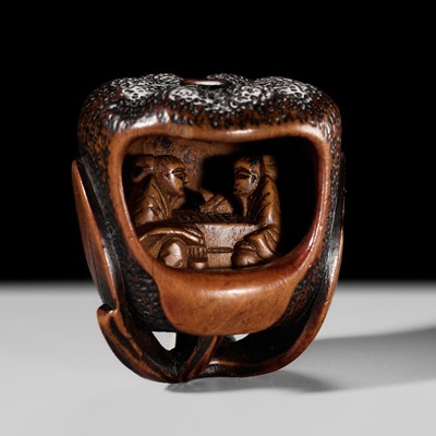 Lot 624 - A FINE ANABORI WOOD NETSUKE OF TWO SAGES PLAYING GO INSIDE A MIKAN