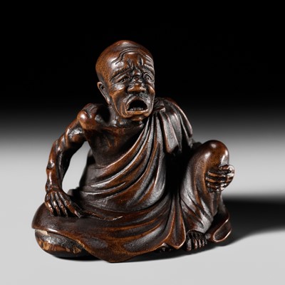 Lot 258 - HOSHUNSAI MASAYUKI: A WOOD NETSUKE OF A RAKAN APPLYING MOXA