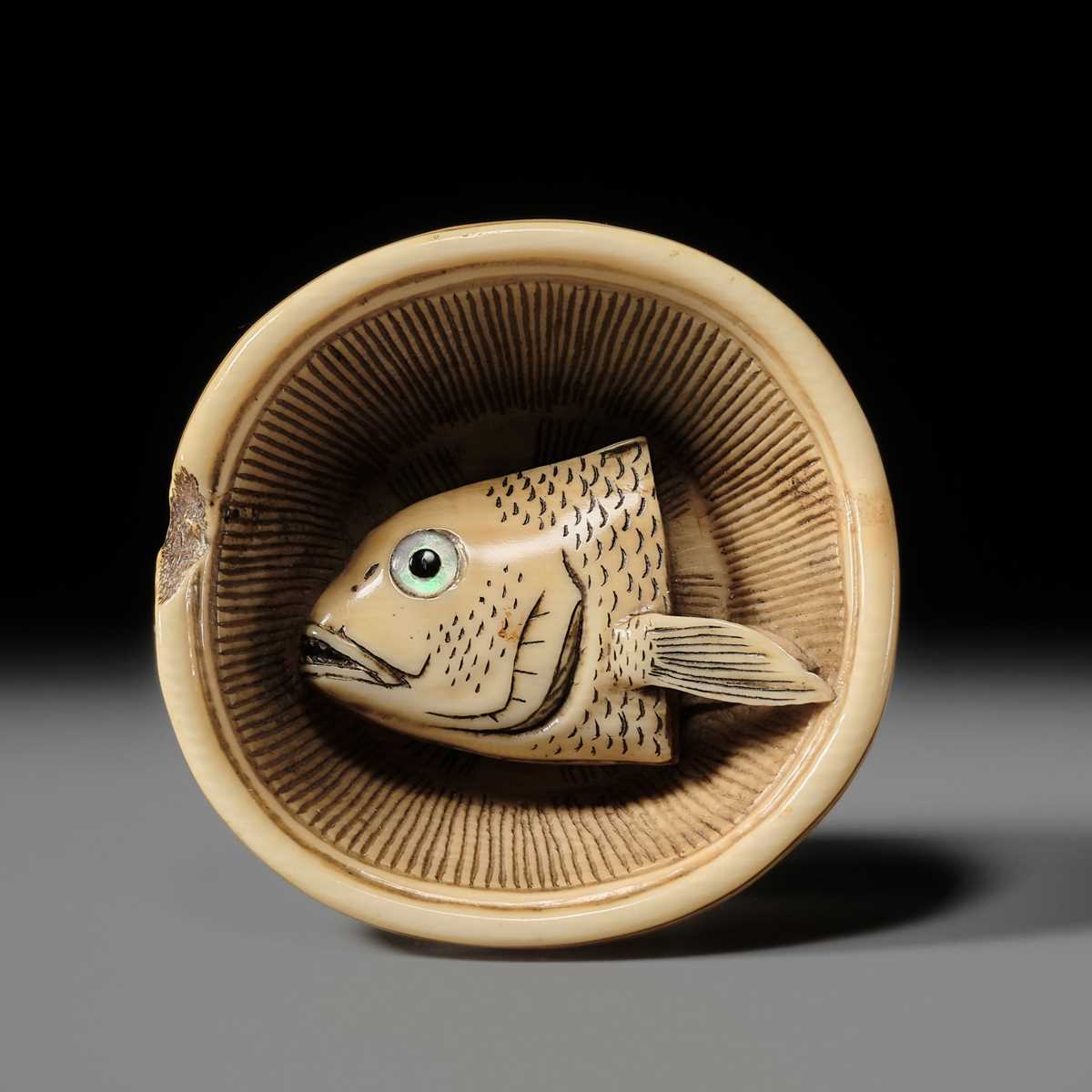 OHARA MITSUHIRO: A SUPERB IVORY NETSUKE OF A SEA BREAM HEAD IN A SURIBACHI (MORTAR), DATED 1855