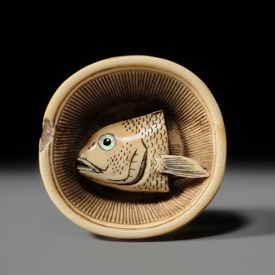 Lot 142 - OHARA MITSUHIRO: A SUPERB IVORY NETSUKE OF A SEA BREAM HEAD IN A SURIBACHI (MORTAR), DATED 1855