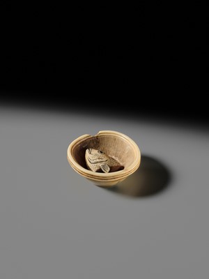 OHARA MITSUHIRO: A SUPERB IVORY NETSUKE OF A SEA BREAM HEAD IN A SURIBACHI (MORTAR), DATED 1855