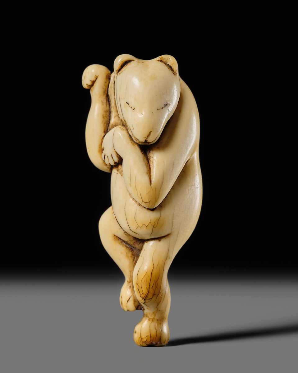 Lot 127 - HIDEMASA: A RARE AND SUPERB IVORY NETSUKE OF A DANCING KITSUNE