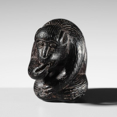 MIWA: A WOOD NETSUKE OF A MONKEY PICKING FLEAS