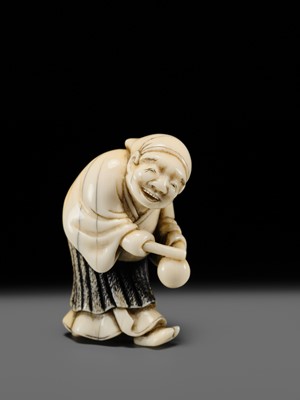 Lot 134 - MAZAKAZU: AN IVORY NETSUKE OF A HACHI-TATAKI PERFORMER