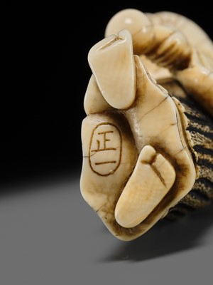 Lot 134 - MAZAKAZU: AN IVORY NETSUKE OF A HACHI-TATAKI PERFORMER