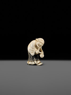 Lot 134 - MAZAKAZU: AN IVORY NETSUKE OF A HACHI-TATAKI PERFORMER