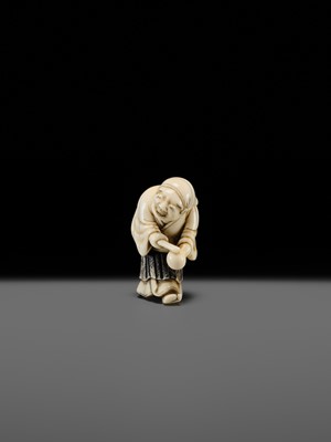 Lot 134 - MAZAKAZU: AN IVORY NETSUKE OF A HACHI-TATAKI PERFORMER