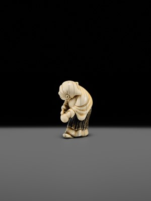 Lot 134 - MAZAKAZU: AN IVORY NETSUKE OF A HACHI-TATAKI PERFORMER