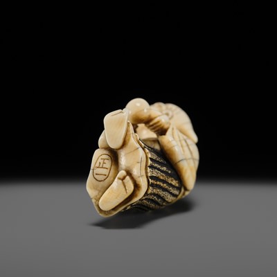 Lot 134 - MAZAKAZU: AN IVORY NETSUKE OF A HACHI-TATAKI PERFORMER