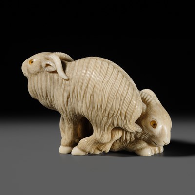 Lot 376 - MASATOSHI: A SUPERB IVORY NETSUKE OF TWO GOATS, AFTER MATSUSHITA OTOMAN