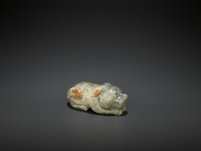 Lot 72 - A CARVED CELADON AND RUSSET JADE FIGURE OF A DOG, LATE MING DYNASTY