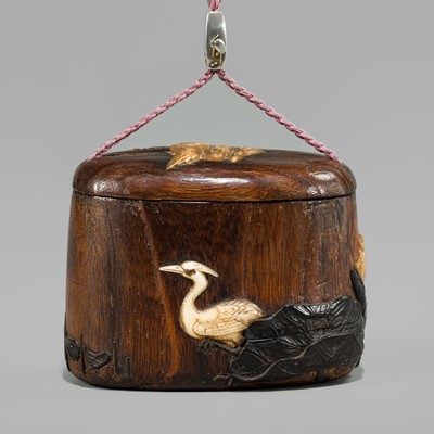 JAKUO: AN INLAID PAULOWNIA WOOD TONKOTSU WITH A FINE SILVER OJIME