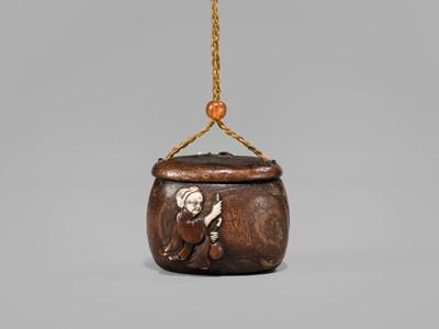Lot 394 - TANAKA MINKO: AN INLAID WOOD TONKOTSU WITH A RAOYA CLEANING A SMOKING PIPE (KISERU)