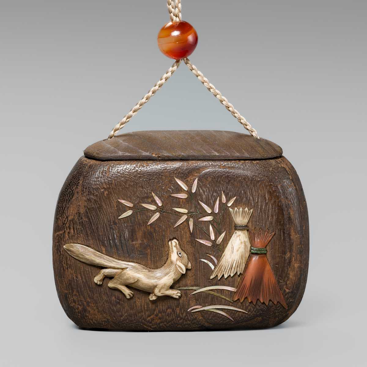 Lot 66 - A FINE INLAID KIRI WOOD TONKOTSU (TOBACCO CONTAINER) DEPICTING A KITSUNE (FOX)
