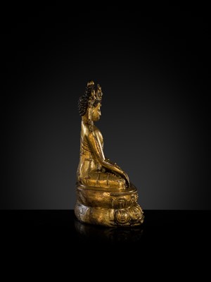 A TURQUOISE-INLAID GILT COPPER-ALLOY FIGURE OF THE CROWNED BUDDHA, TIBET, CIRCA 15TH-16TH CENTURY