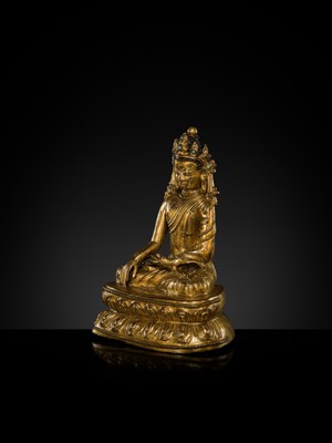 A TURQUOISE-INLAID GILT COPPER-ALLOY FIGURE OF THE CROWNED BUDDHA, TIBET, CIRCA 15TH-16TH CENTURY