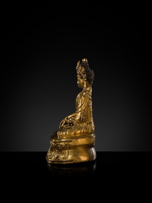 A TURQUOISE-INLAID GILT COPPER-ALLOY FIGURE OF THE CROWNED BUDDHA, TIBET, CIRCA 15TH-16TH CENTURY