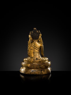 A TURQUOISE-INLAID GILT COPPER-ALLOY FIGURE OF THE CROWNED BUDDHA, TIBET, CIRCA 15TH-16TH CENTURY