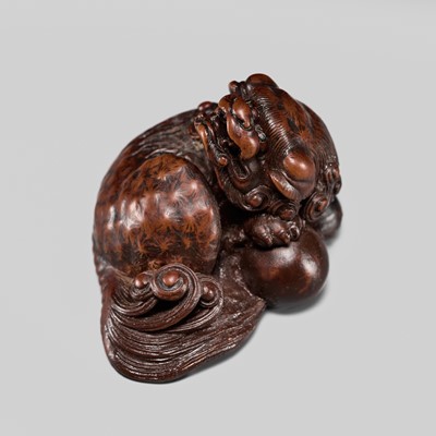 Lot 246 - TOUN: A FINE WOOD NETSUKE OF A SHISHI WITH A BALL