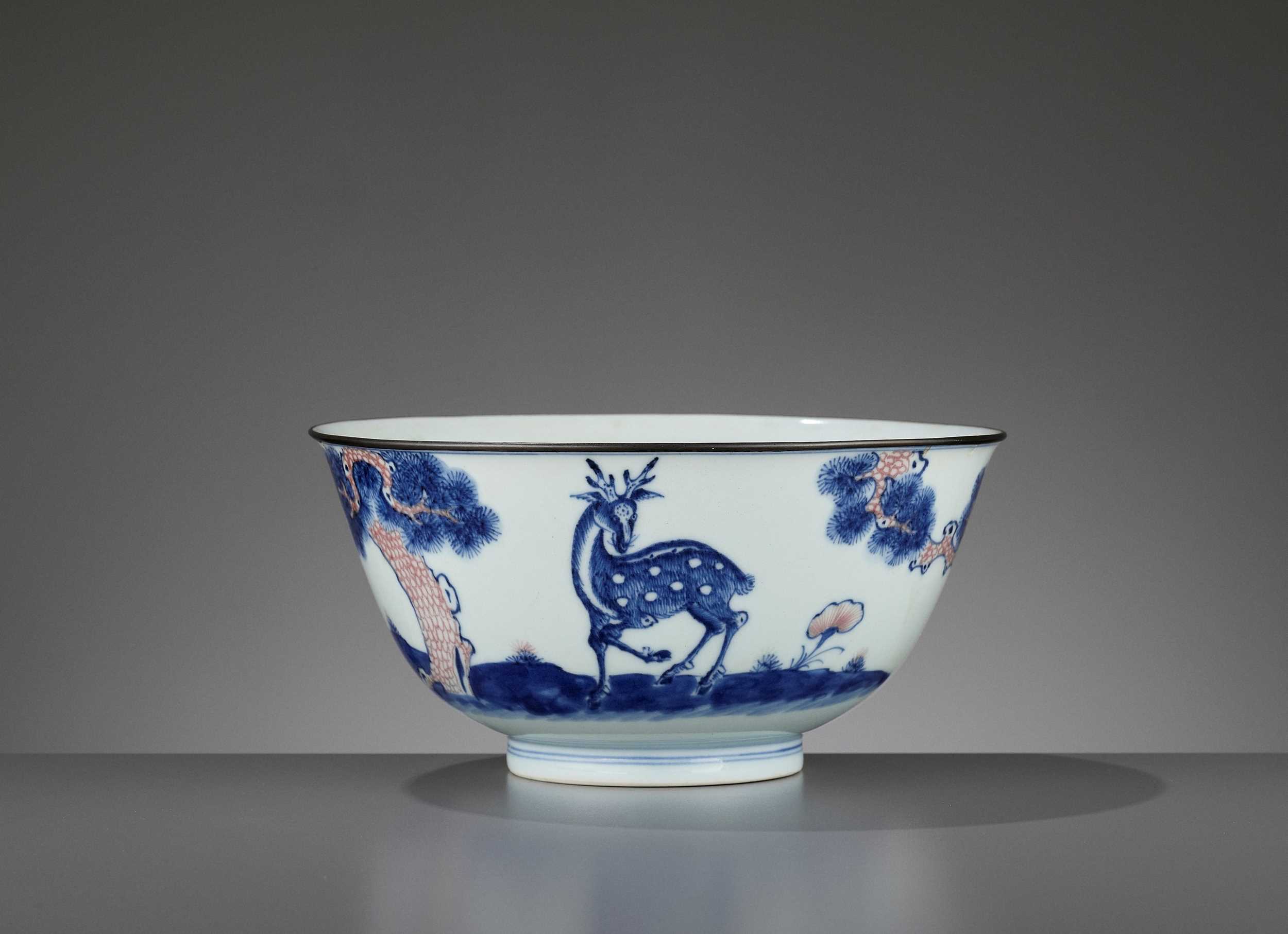 Lot 256 - A COPPER-RED-DECORATED BLUE AND WHITE ‘DEER’ BOWL, QIANLONG MARK AND PERIOD