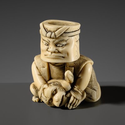Lot 503 - A VERY RARE IVORY NETSUKE OF A BUCKET-HEADED YOKAI SAMURAI SUBDUING A MONKEY