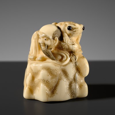 GARAKU: A RARE NARWHAL TUSK NETSUKE OF GAMA SENNIN ON A ROCK