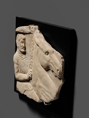 Lot 65 - A ROMAN WHITE MARBLE RELIEF FRAGMENT OF A SARCOPHAGUS DEPICTING A HORSEMAN AND STEED, CIRCA 2ND CENTURY AD