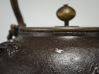 Lot 43 - RYUBUNDO: AN IRON TEA KETTLE (TETSUBIN) WITH A NOCTURNAL LANDSCAPE UNDER THE CRESCENT MOON