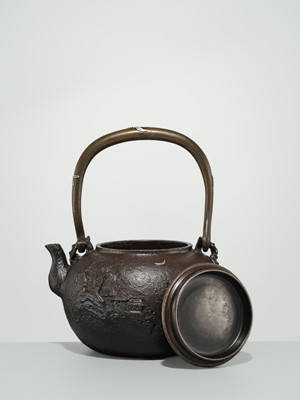 Lot 43 - RYUBUNDO: AN IRON TEA KETTLE (TETSUBIN) WITH A NOCTURNAL LANDSCAPE UNDER THE CRESCENT MOON