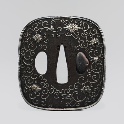 AN IRON TSUBA WITH SILVER KARAKUSA TENDRILS