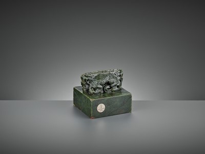 Lot 64 - AN IMPERIAL ‘DOUBLE DRAGON’ SPINACH-GREEN JADE SEAL, THE SEAL FACE INSCRIBED IN MANCHU AND CHINESE